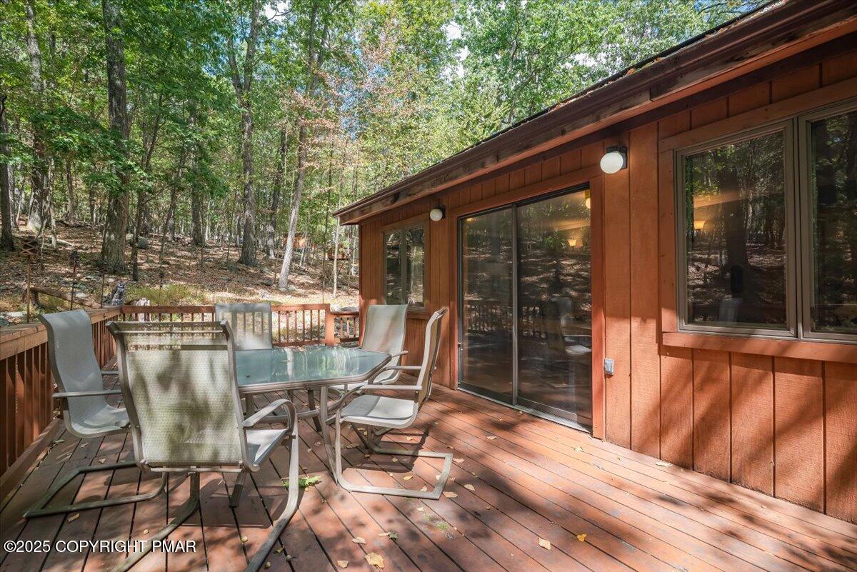 2108 Scarborough Way Bushkill, PA 18324 - Photo 55 of 105 a view of a patio with table and chairs with wooden floor and fence