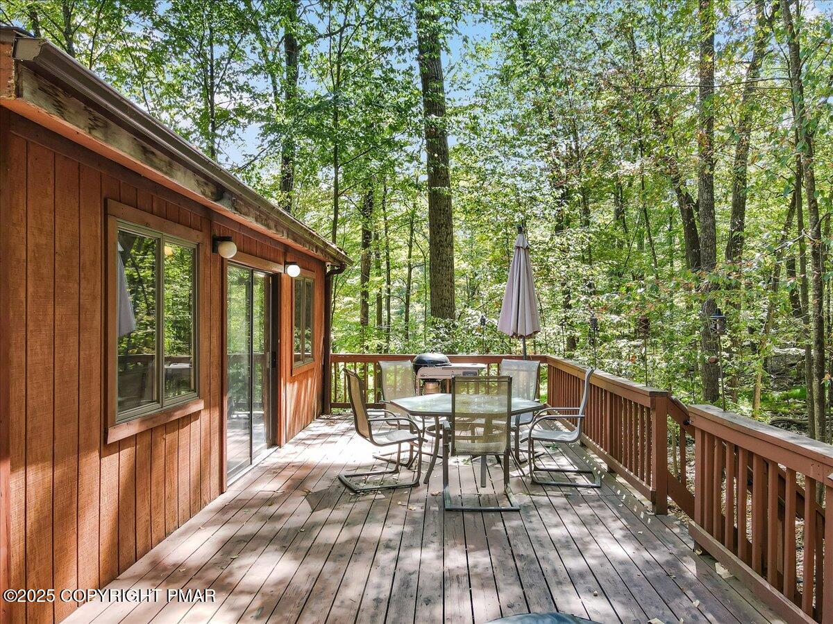 2108 Scarborough Way Bushkill, PA 18324 - Photo 58 of 105 a view of a patio with table and chairs and wooden floor