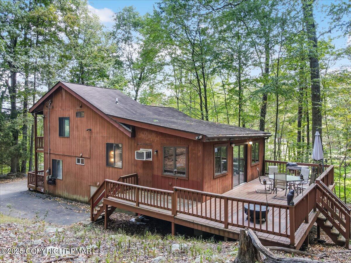 2108 Scarborough Way Bushkill, PA 18324 - Photo 61 of 105 a view of a house with a wooden deck and furniture