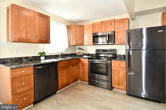 a kitchen with a sink stove and refrigerator