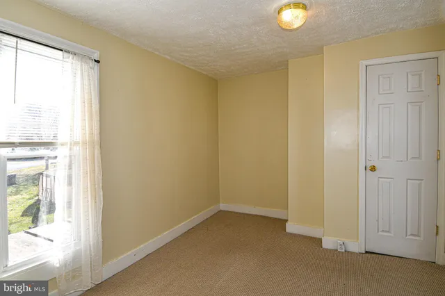 a view of an empty room and a window