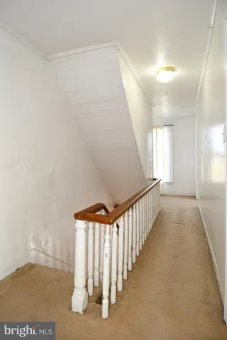 a view of a hallway with stairs