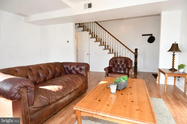 a living room with a couch and a wooden floor