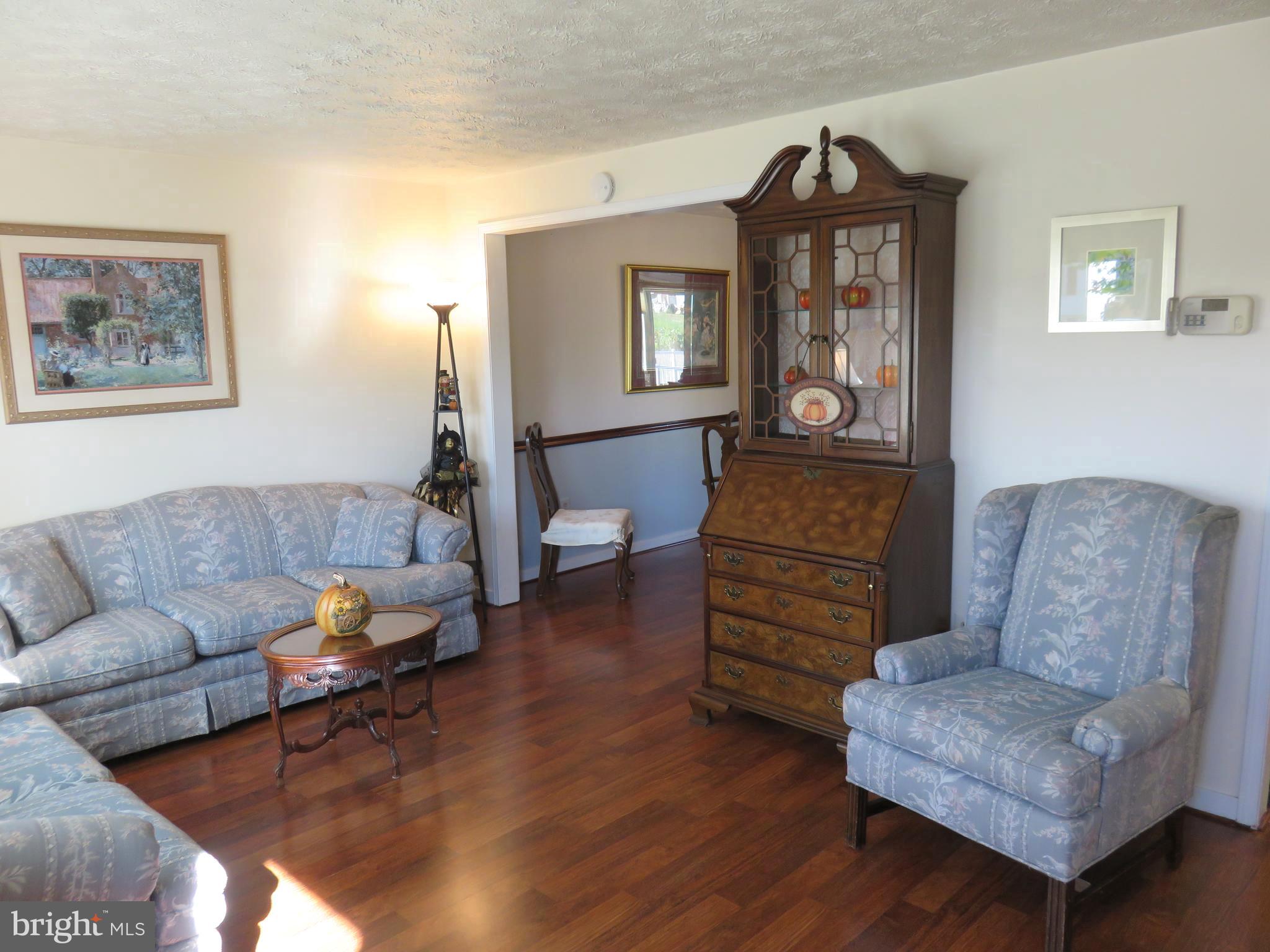 6823 Fordcrest Road Baltimore, MD 21237 - Photo 3 of 32 a living room with furniture and a wooden floor