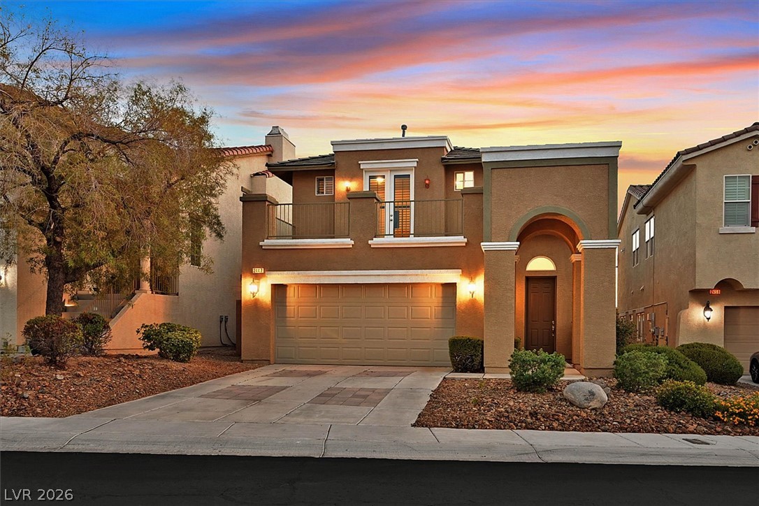 2447 Kaymin Ridge Road Henderson, NV 89052 - Photo 1 of 40 An arched entry and private balcony highlight the stucco exterior of this multi-level home.