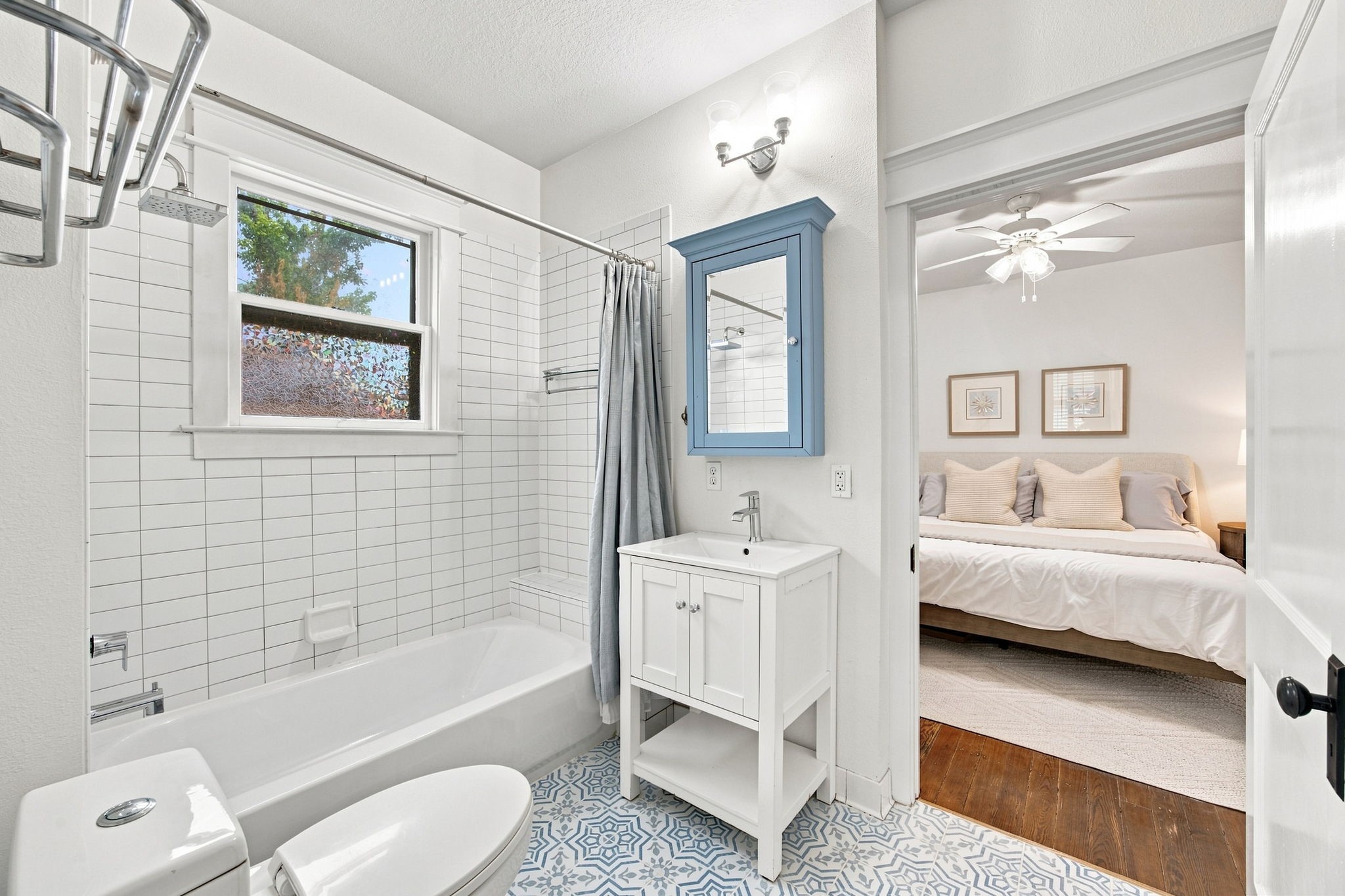 4618 McEwen Street Houston, TX 77009 - Photo 14 of 39 The primary bathroom is the epitome of historic accents in a fully updated space. Notice the classic tile choices, as well as the tub/shower combo, and generous storage behind the door to the right.