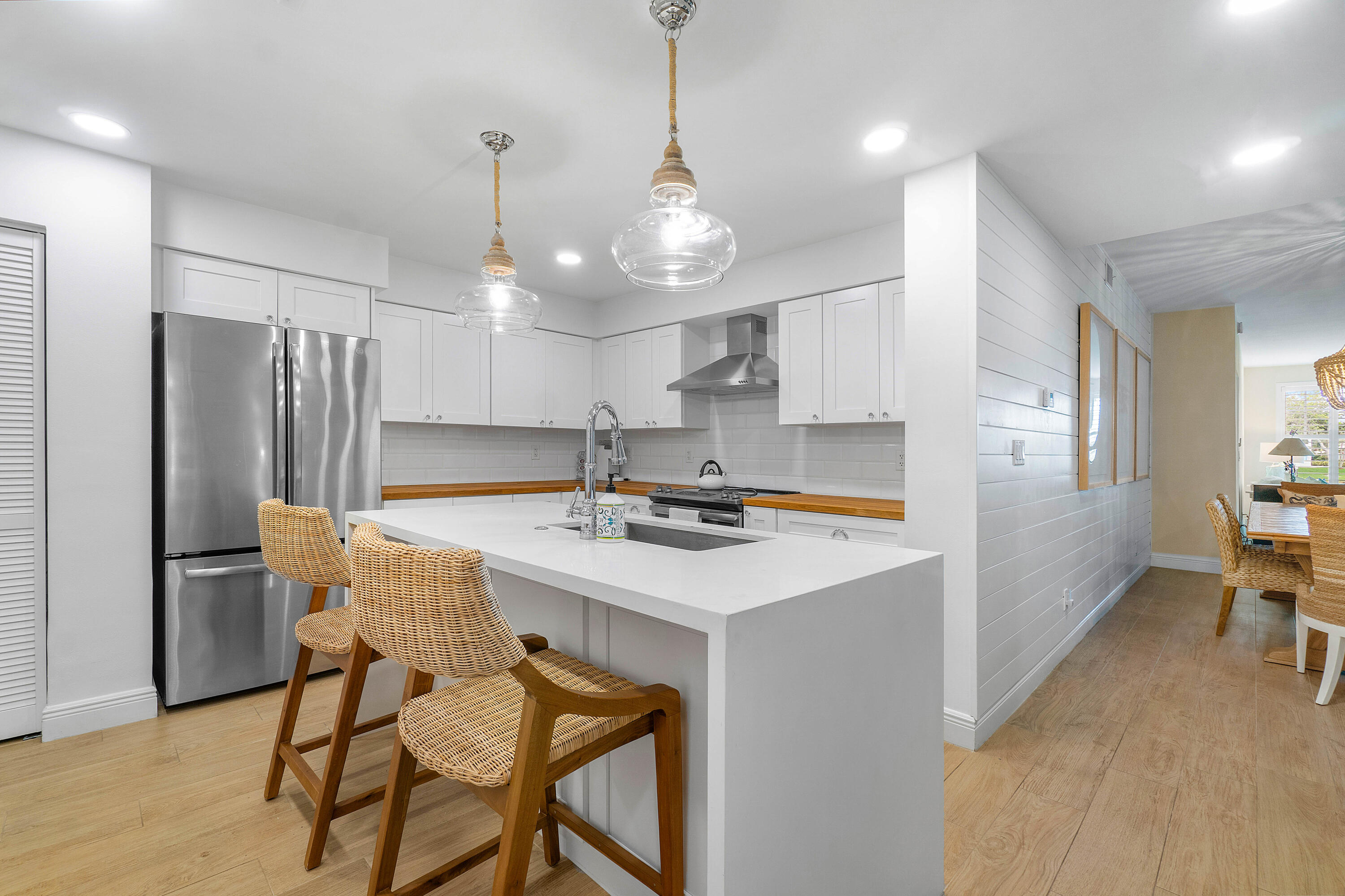 807 Mainsail Circle Jupiter, FL 33477 - Photo 9 of 35 a kitchen with stainless steel appliances a sink a stove a refrigerator a center island and a table