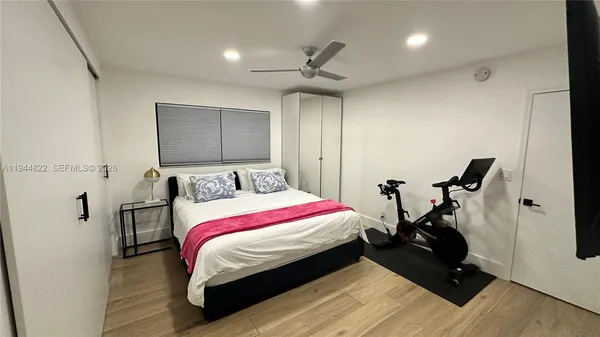 a room with a bed and wooden floor