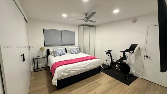 a room with a bed and wooden floor