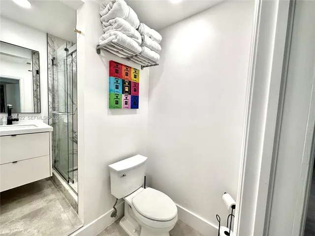 a bathroom with a sink a toilet and shower curtain