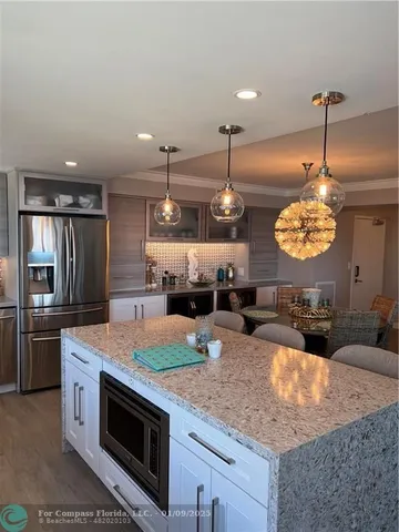 a kitchen with stainless steel appliances granite countertop a stove a oven and a counter space