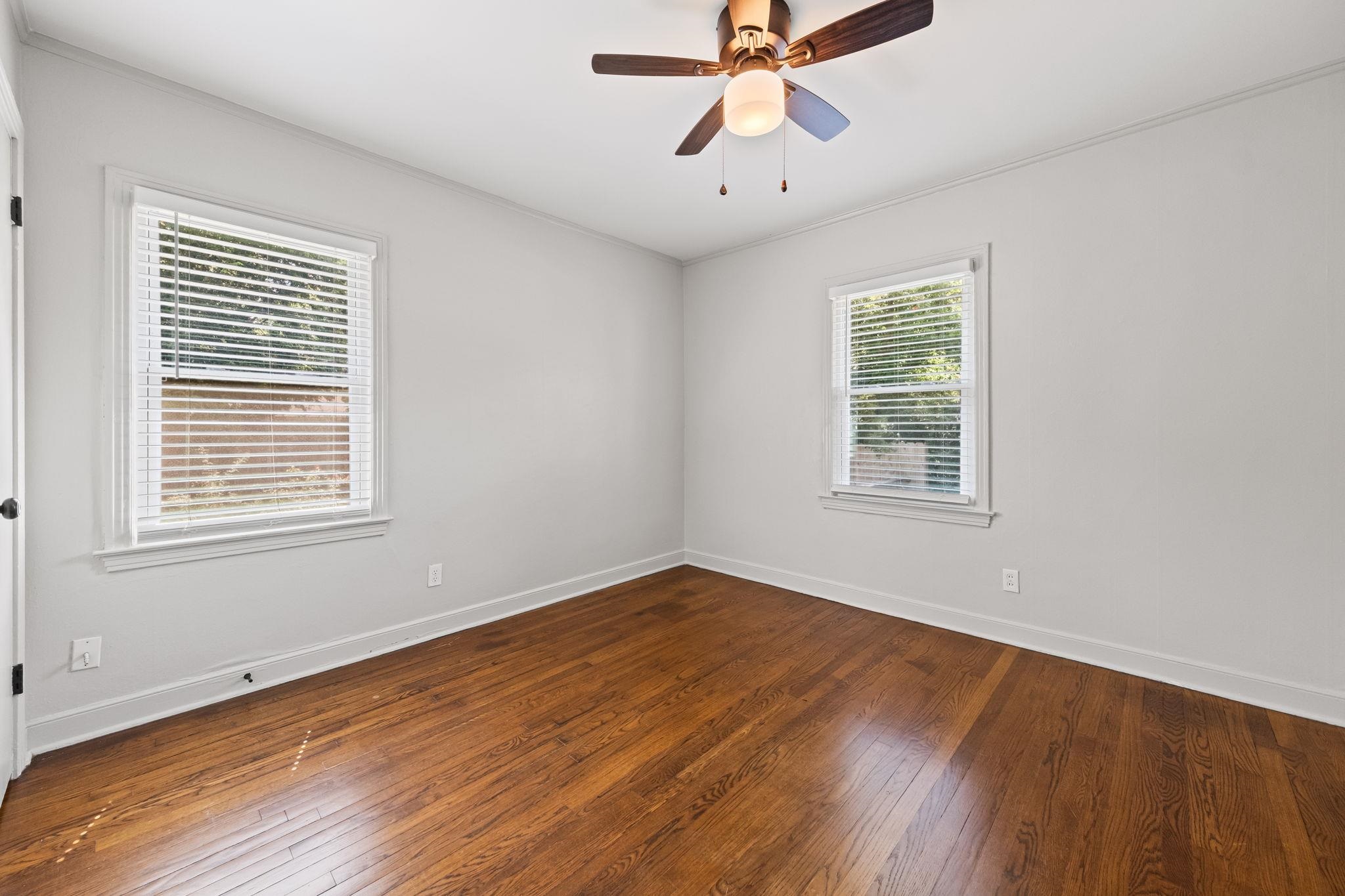 688 Berry Road Memphis, TN 38117 - Photo 7 of 16 Unfurnished room with wood-type flooring, crown molding, and ceiling fan