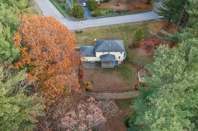 an aerial view of a house with a yard