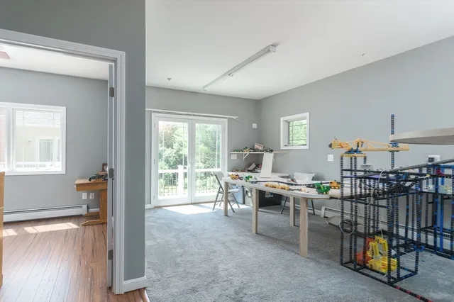 a view of a workspace with furniture and window