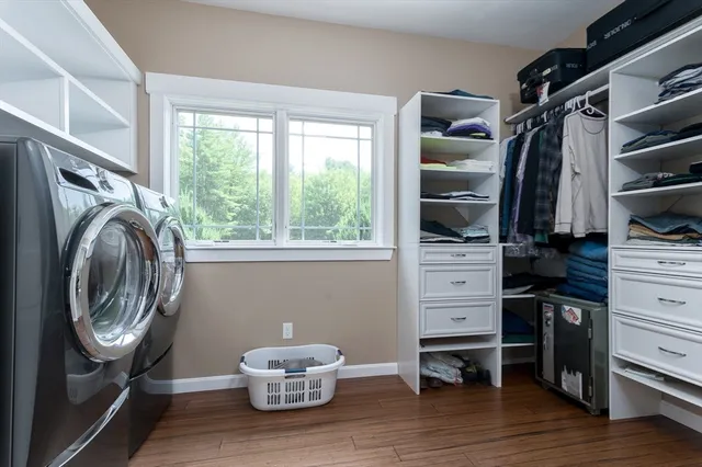 a view of walk in closet with clothes and shoes