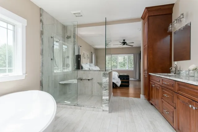 a bathroom with a tub sink and mirror