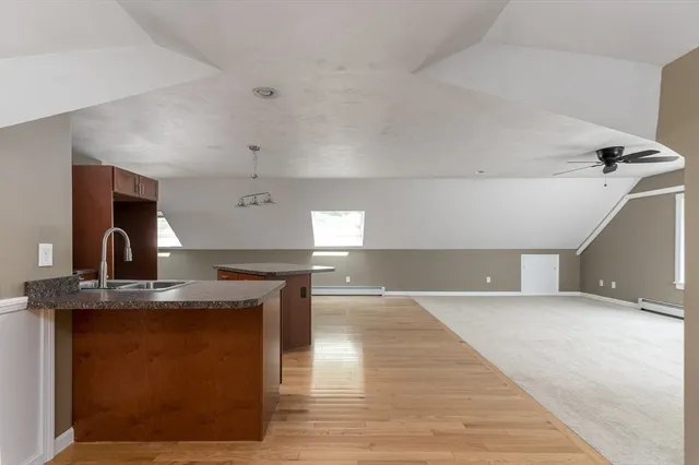 a kitchen with stainless steel appliances granite countertop a sink and a stove