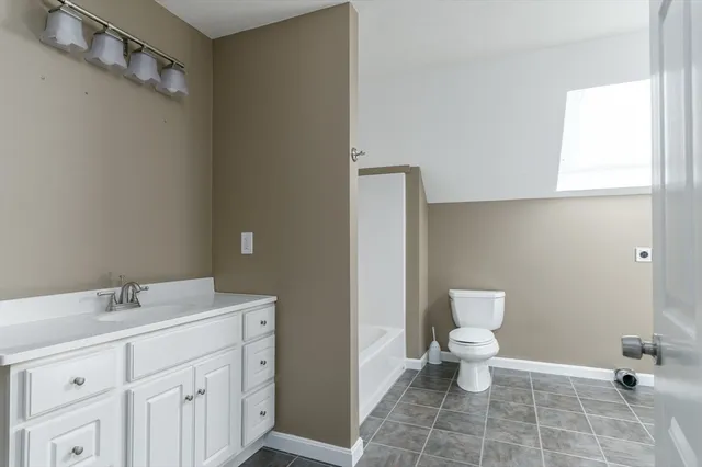 a bathroom with a sink toilet and vanity