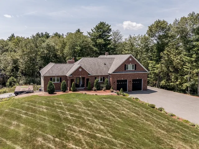a front view of a house with a yard garage and outdoor seating