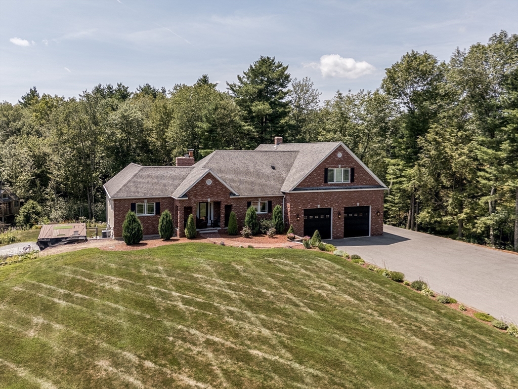 77 Barrel Road Westminster, MA 01473 - Photo 40 of 42 a front view of a house with a yard garage and outdoor seating