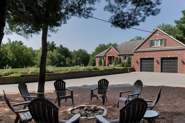 a view of a patio with lawn chairs floor to ceiling window and a yard