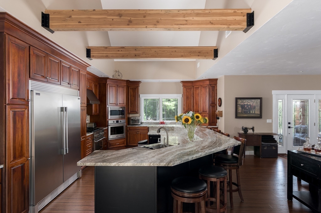 77 Barrel Road Westminster, MA 01473 - Photo 5 of 42 a kitchen with stainless steel appliances granite countertop a refrigerator a stove a sink dishwasher with a dining table and chairs