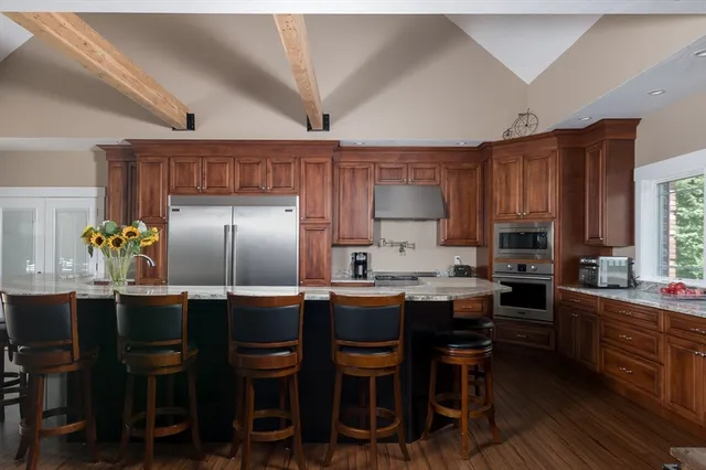 a kitchen with cabinets and chairs