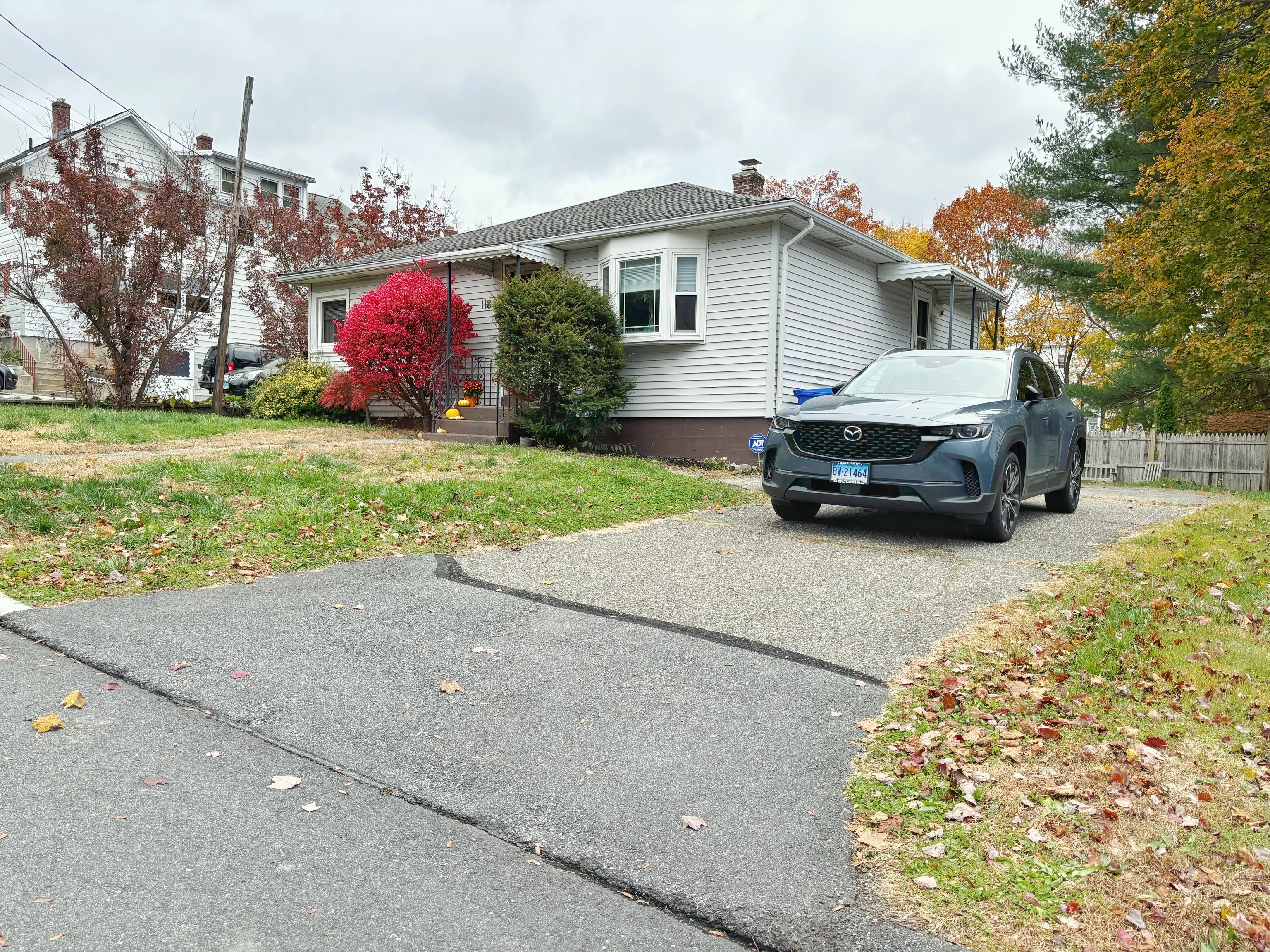 118 Bannon Street Torrington, CT 06790 - Photo 26 of 27 a car parked in front of a house next to a yard
