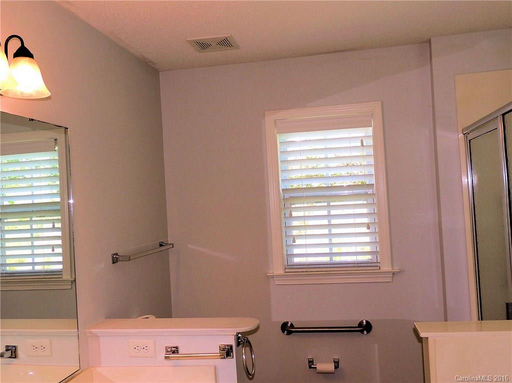 56 Morning Mist Road, Unit 76 Fletcher, NC 28732 - Photo 12 of 16 a bathroom with a bathtub and a window