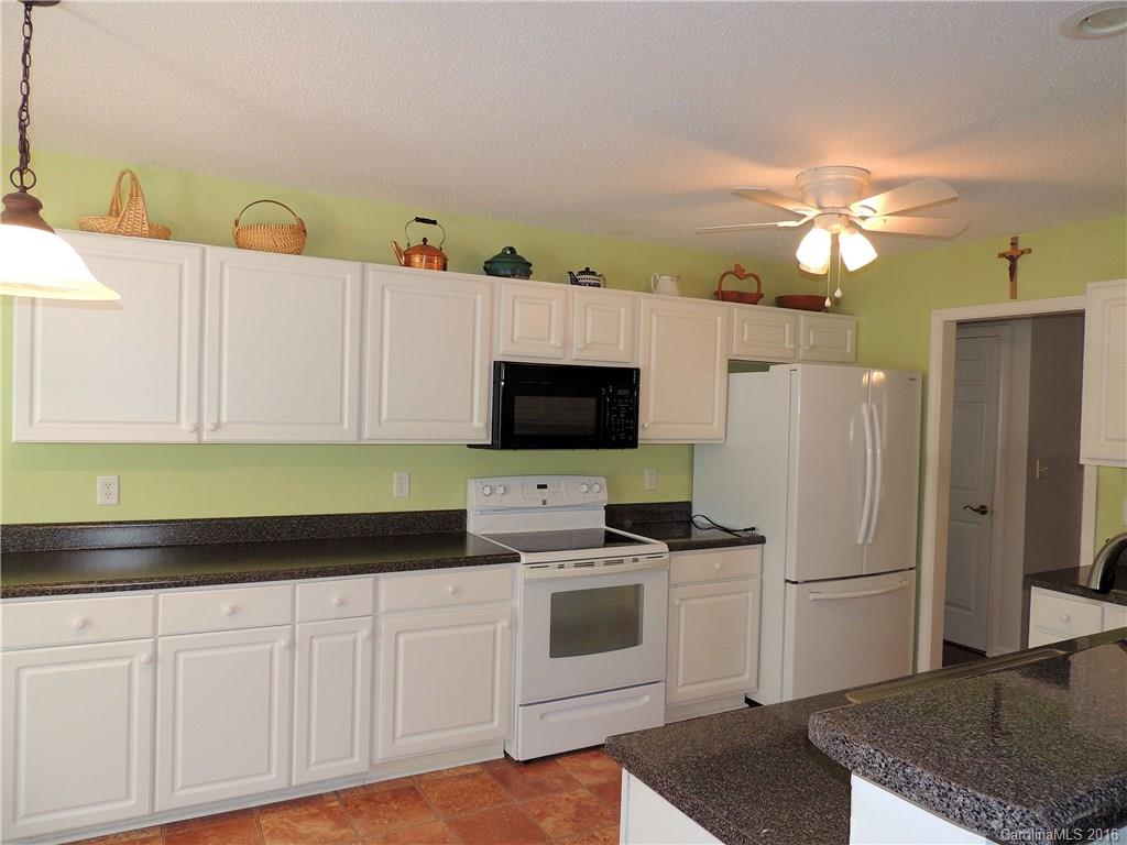 56 Morning Mist Road, Unit 76 Fletcher, NC 28732 - Photo 5 of 16 a kitchen with cabinets and white stainless steel appliances