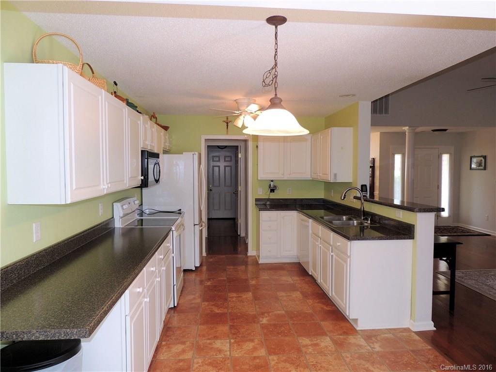 56 Morning Mist Road, Unit 76 Fletcher, NC 28732 - Photo 6 of 16 a kitchen with stainless steel appliances granite countertop a sink stove and refrigerator