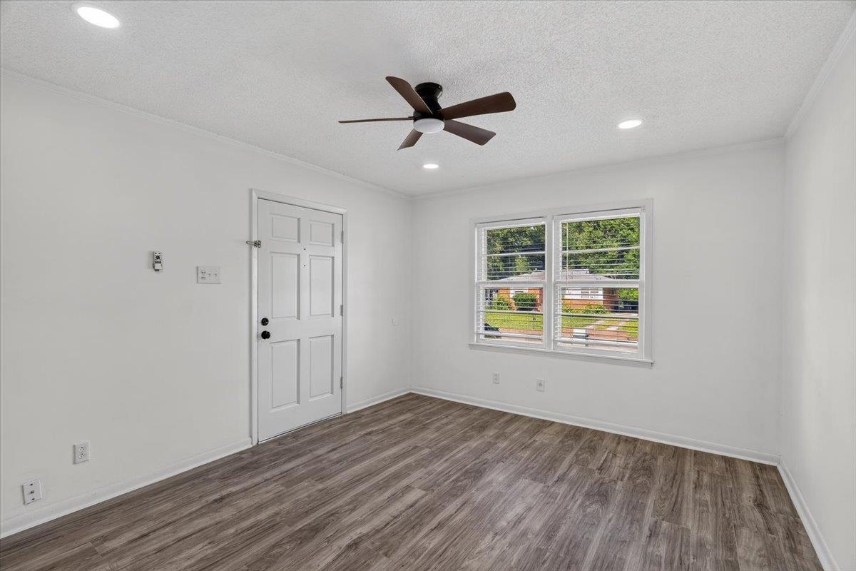 2717 Merle Street Memphis, TN 38118 - Photo 6 of 18 Bright room featuring wood-finish flooring, a white paneled door, a ceiling fan with integrated lighting, recessed lighting, and a double window with blinds