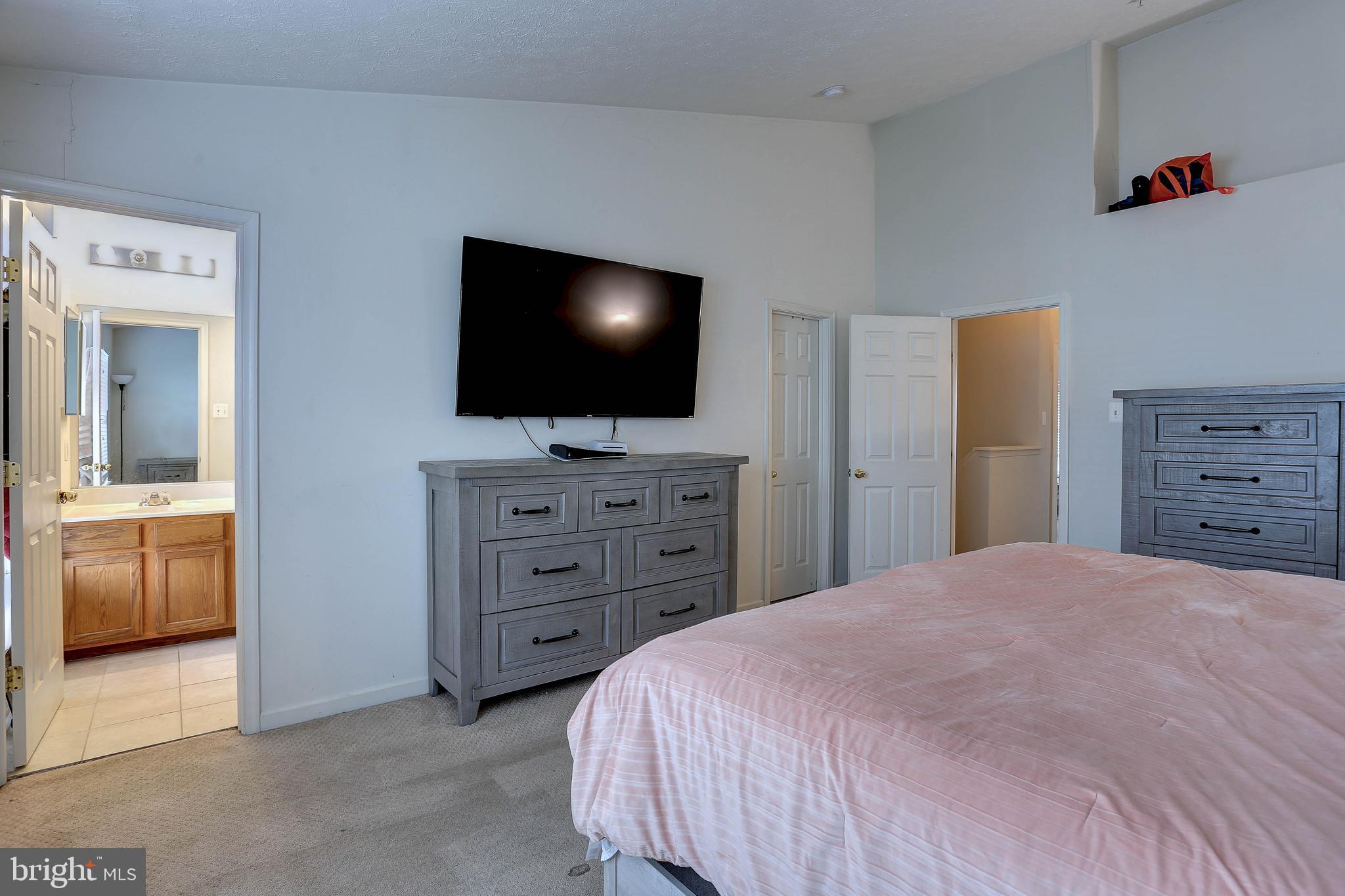 819 Lowe Road Middle River, MD 21220 - Photo 15 of 26 a bedroom with a bed and a flat screen tv