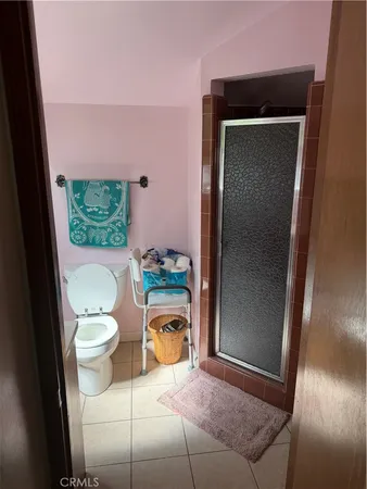 a bathroom with a toilet and a shower