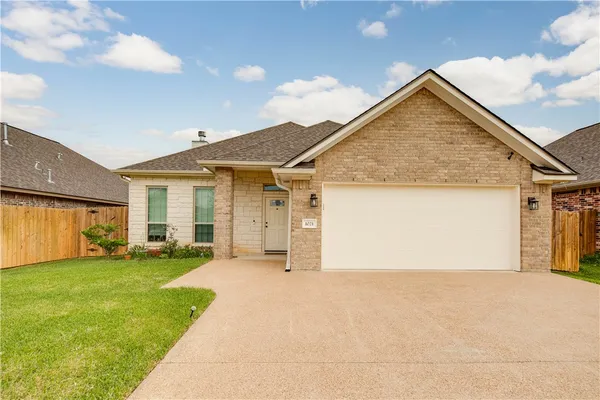 a view of a house with a yard and garage