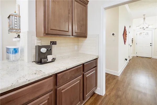 a kitchen with stainless steel appliances granite countertop a sink a stove and wooden floor