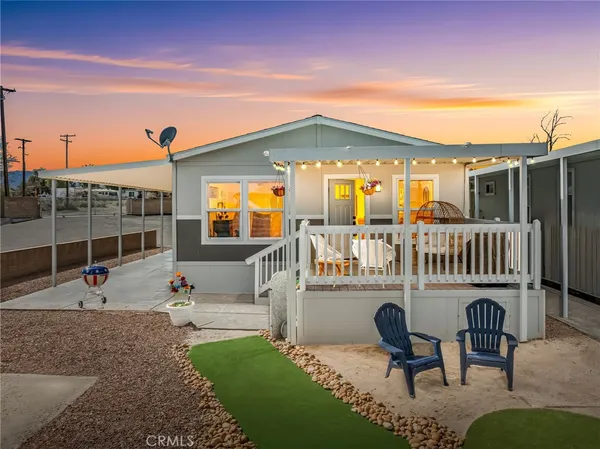 a view of a house with a patio and a garden