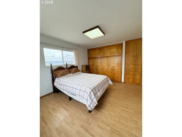 a bedroom with a bed and a night stand