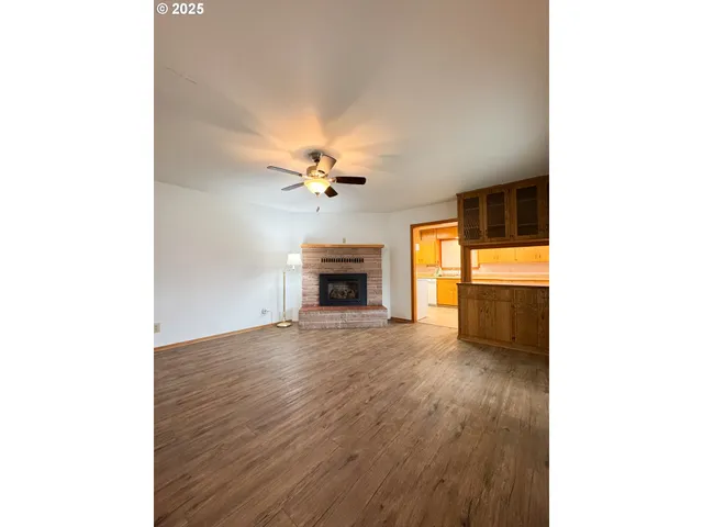 a view of an empty room with a fireplace