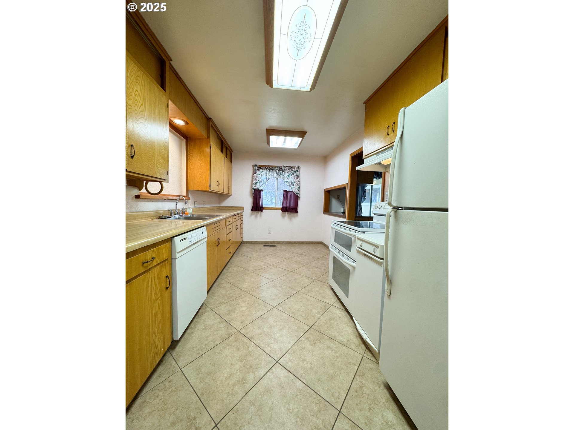 2050 Birch Street Baker City, OR 97814 - Photo 7 of 31 a kitchen with stainless steel appliances granite countertop a sink and cabinets
