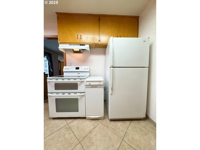 a utility room with cabinets washer and dryer