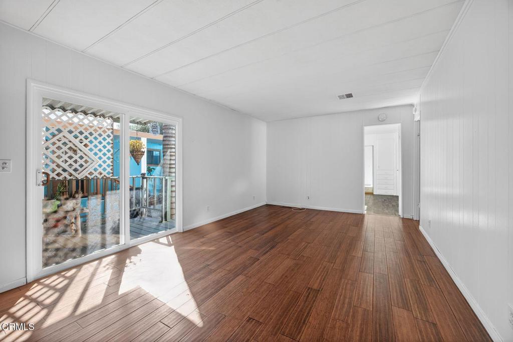 5540 West 5th Street, Unit 111 Oxnard, CA 93035 - Photo 14 of 35 a view of a room with wooden floor and balcony