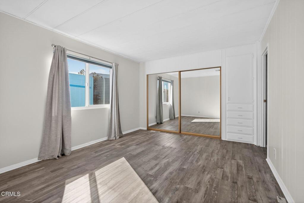 5540 West 5th Street, Unit 111 Oxnard, CA 93035 - Photo 16 of 35 a view of empty room with wooden floor and entryway