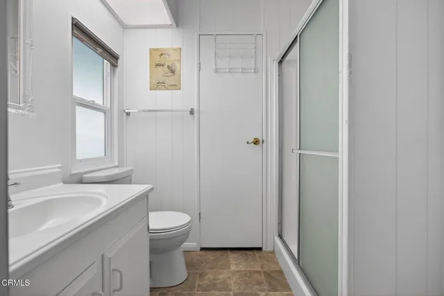 a bathroom with a sink toilet and mirror