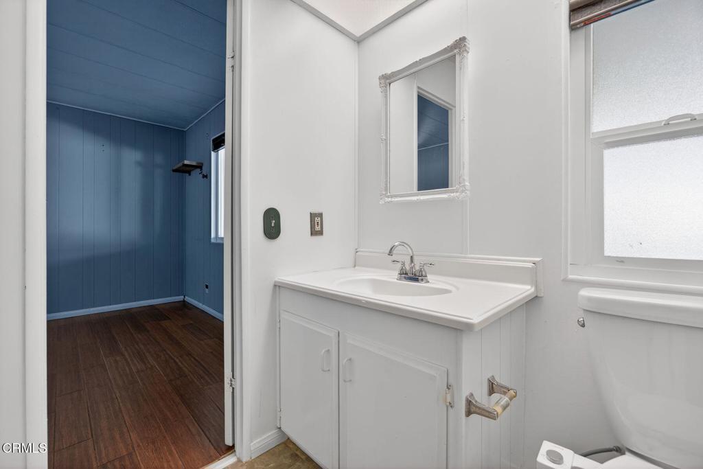 5540 West 5th Street, Unit 111 Oxnard, CA 93035 - Photo 24 of 35 a bathroom with a sink toilet and mirror