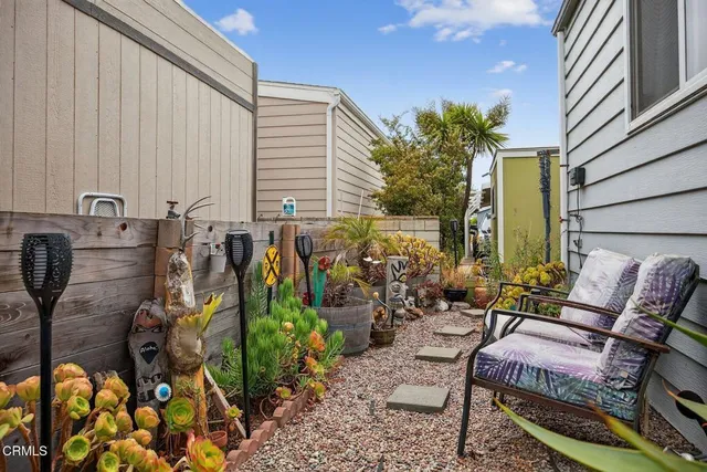 a balcony with lots of potted plants