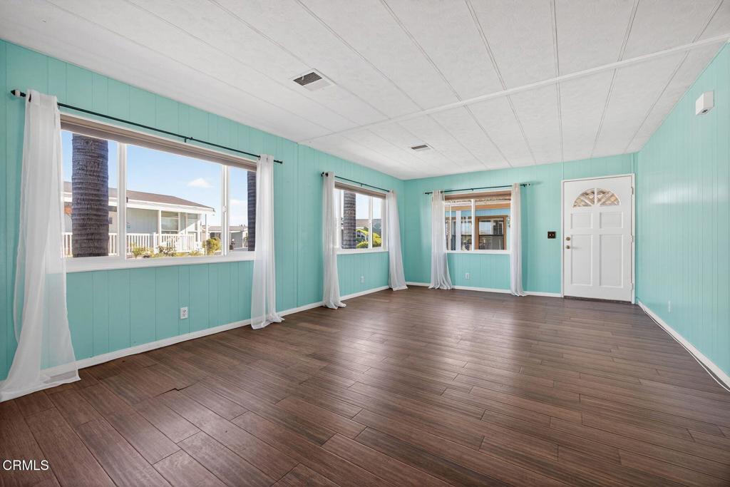 5540 West 5th Street, Unit 111 Oxnard, CA 93035 - Photo 5 of 35 a view of empty room with wooden floor and fan
