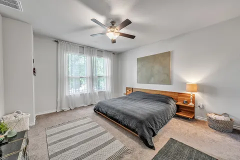 a bedroom with a large bed and window
