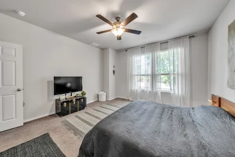 a bedroom with a bed and a flat screen tv