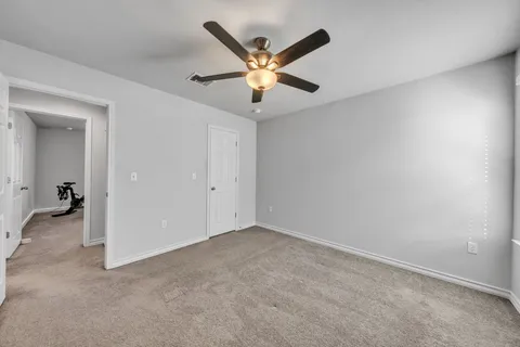 an empty room with ceiling fan and ceiling fan